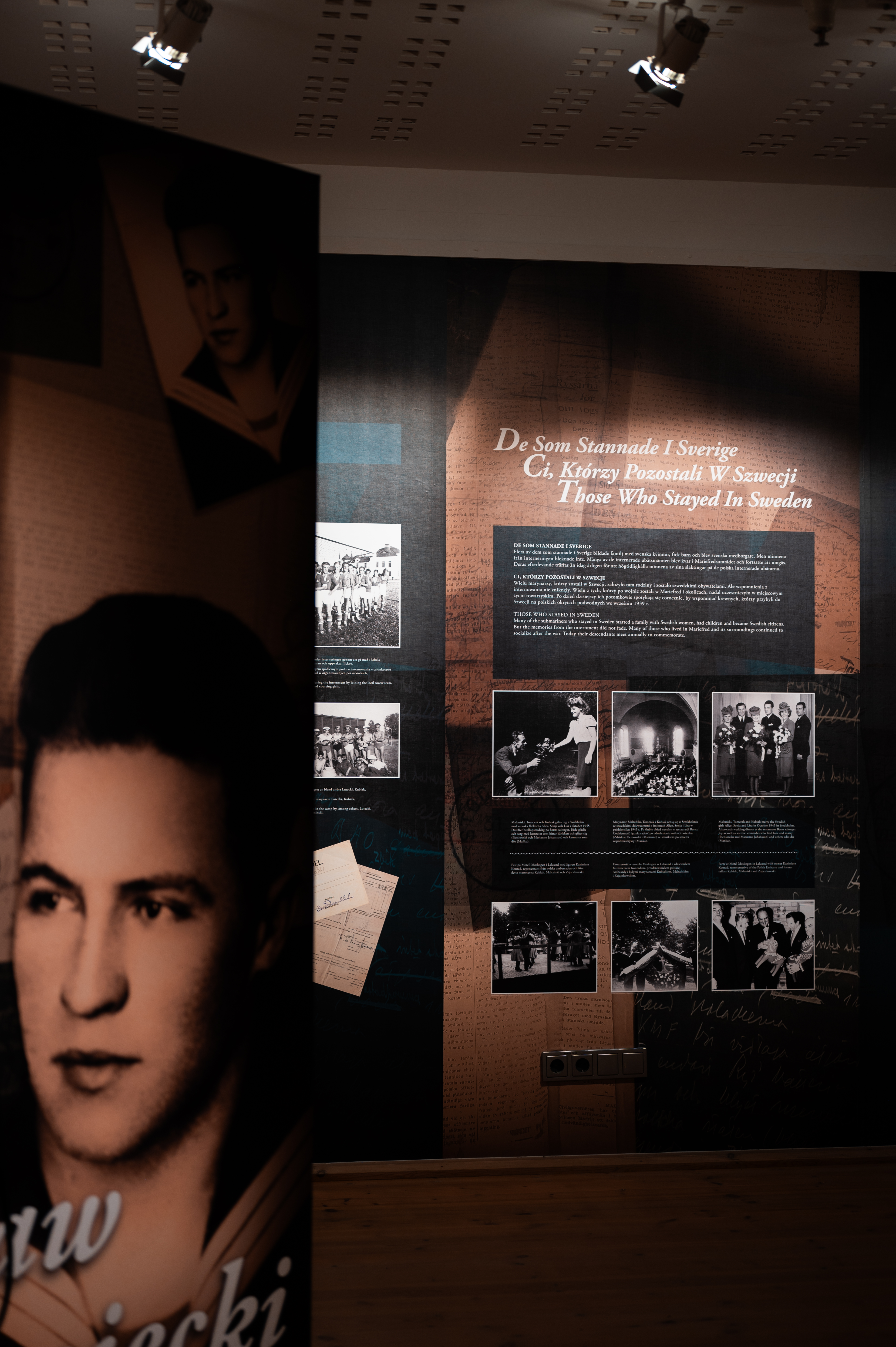 Photographs of people from the past and texts sit on the wall in the exhibition room.