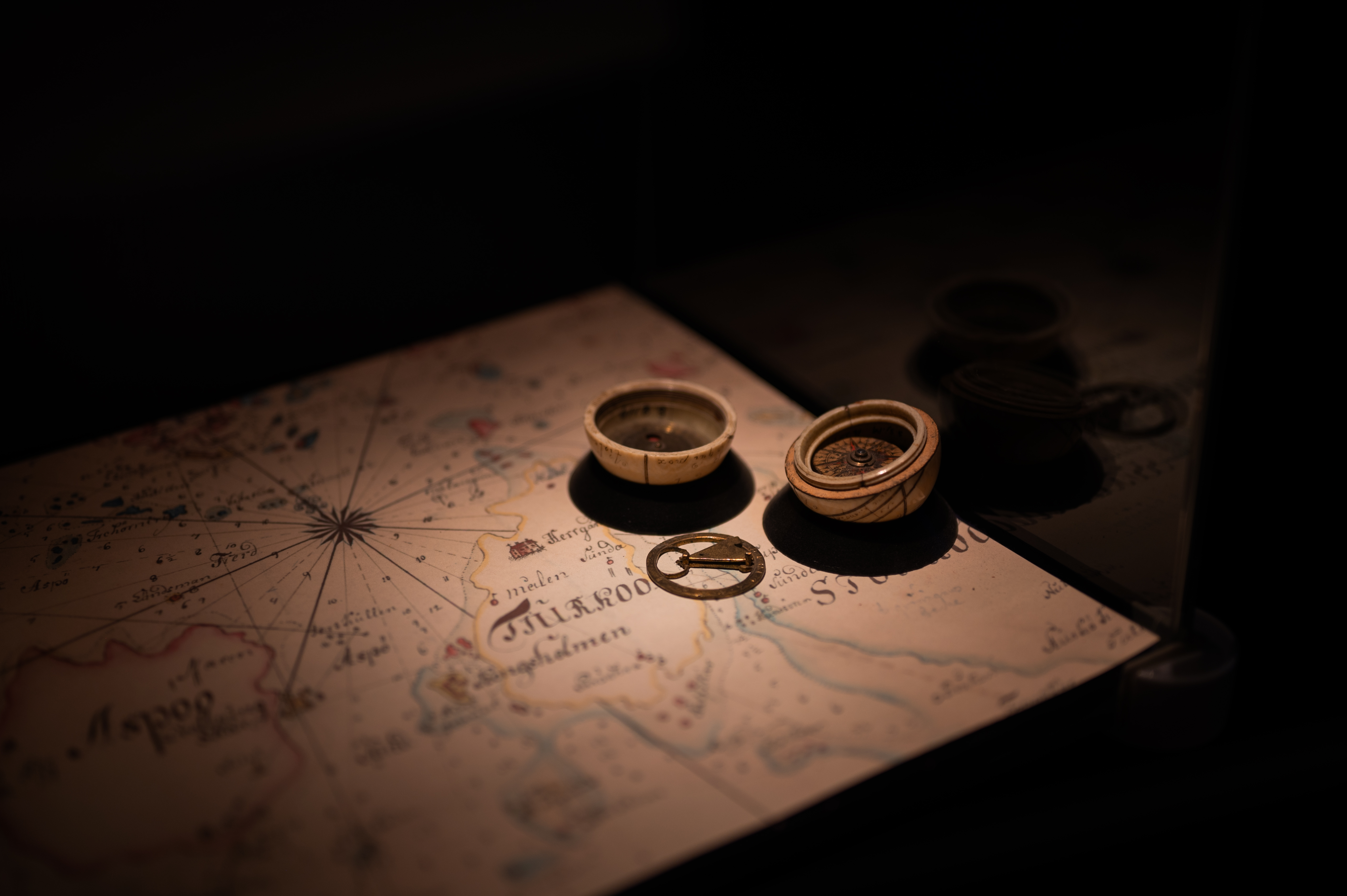 A nautical chart with a historic compass.