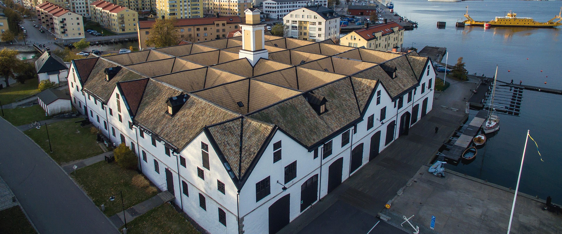 White old buildings next to water, photographed from above.
