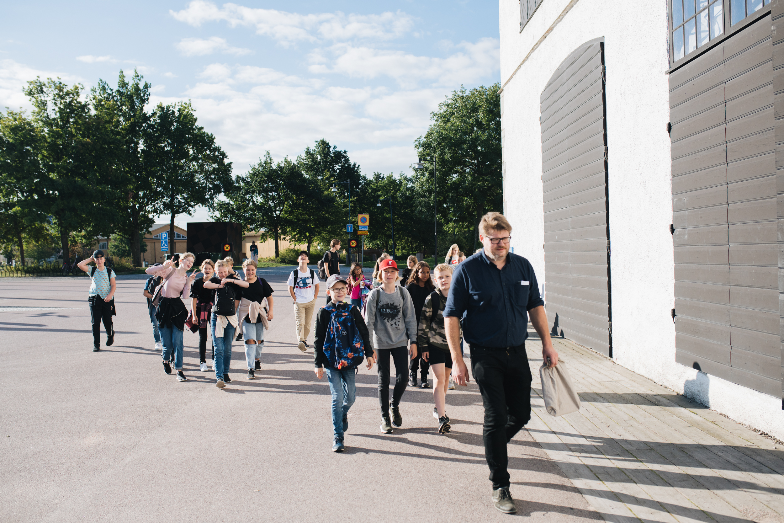 En vuxen går tillsammans med en skolklass